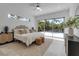 Bedroom with a neutral palette, slider door to outdoor patio and ensuite bathroom at 2124 Clematis Pl, Sarasota, FL 34239