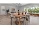 Open-concept room with modern chairs around a wooden table, lots of light, and access to the outdoor oasis at 2124 Clematis Pl, Sarasota, FL 34239