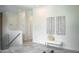 Bright foyer showcasing sleek tile floors, glass-paneled staircase, and stylish seating area with modern art at 2124 Clematis Pl, Sarasota, FL 34239