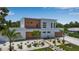 Contemporary white and wood home with tidy landscaping, paved walkway, and manicured lawn at 2124 Clematis Pl, Sarasota, FL 34239