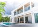 Stunning two-story home with modern architecture, multiple balconies, and a refreshing pool area at 2124 Clematis Pl, Sarasota, FL 34239