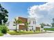 Modern two-story home featuring a flat roof, wood accents, and a manicured front yard with tropical landscaping at 2124 Clematis Pl, Sarasota, FL 34239