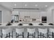 Elegant kitchen featuring a spacious island with bar stools and upscale decorative accents at 2124 Clematis Pl, Sarasota, FL 34239