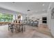 Bright, open kitchen with modern white cabinets, marble countertops, and a large island with barstool seating at 2124 Clematis Pl, Sarasota, FL 34239