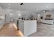 Open kitchen with large center island, sleek white cabinetry, and a view into the living area at 2124 Clematis Pl, Sarasota, FL 34239