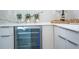 Modern kitchen with stainless steel wine cooler and elegant white countertops at 2124 Clematis Pl, Sarasota, FL 34239