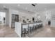 Bright kitchen featuring a large island with bar seating, stainless steel appliances, and tile flooring at 2124 Clematis Pl, Sarasota, FL 34239