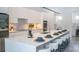 Contemporary kitchen featuring sleek white cabinetry, a large island with seating, and modern appliances at 2124 Clematis Pl, Sarasota, FL 34239