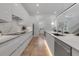 Stylish kitchen with white marble counters, stainless steel appliances, and sleek minimalist design at 2124 Clematis Pl, Sarasota, FL 34239