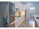 Sleek, white modern kitchen showcasing built-in appliances and a large island with space for barstools at 2124 Clematis Pl, Sarasota, FL 34239