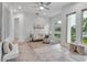 Open-concept living room with neutral tiling, modern furnishings, and an abundance of natural light at 2124 Clematis Pl, Sarasota, FL 34239