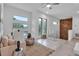 Bright living room featuring modern decor, unique wood accent wall and large windows at 2124 Clematis Pl, Sarasota, FL 34239
