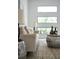 Cozy living room featuring stylish sofa, modern end tables, and a trio of bright windows at 2124 Clematis Pl, Sarasota, FL 34239