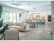 Spacious living room open to kitchen, featuring modern decor, neutral tones, and a sliding glass door at 2124 Clematis Pl, Sarasota, FL 34239