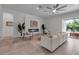 Bright living room featuring a fireplace, modern decor, and a large window offering views of the pool and landscaping at 2124 Clematis Pl, Sarasota, FL 34239