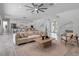 Bright open-concept living space with modern furnishings, large windows, and seamless flow to the kitchen area at 2124 Clematis Pl, Sarasota, FL 34239
