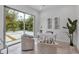 Bright, modern office with backyard views, a decorative desk, and a pair of decorative accent chairs at 2124 Clematis Pl, Sarasota, FL 34239