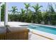 Inviting pool area with lounge seating and lush tropical landscaping offering privacy and relaxation at 2124 Clematis Pl, Sarasota, FL 34239