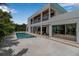 Relaxing poolside view of the home featuring an outdoor seating area and a modern two-story design at 2124 Clematis Pl, Sarasota, FL 34239