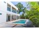 Beautiful backyard featuring a sparkling pool, well-maintained landscaping, and a modern two-story home at 2124 Clematis Pl, Sarasota, FL 34239