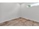Empty room features neutral tiling, white walls, baseboards, and bright natural light from a single window at 2124 Clematis Pl, Sarasota, FL 34239