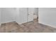 Empty room featuring neutral-toned tiling, white baseboards and walls, and a single-panel door at 2124 Clematis Pl, Sarasota, FL 34239