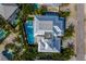 A bird's eye view of a luxury home with a private pool and spa surrounded by tropical landscaping at 227 S Harbor Dr, Holmes Beach, FL 34217