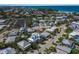 Scenic aerial view of a coastal community featuring modern homes with pools and access to the beach at 227 S Harbor Dr, Holmes Beach, FL 34217