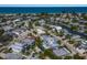Beautiful aerial view of coastal neighborhood with waterfront homes and lush landscaping near the ocean at 227 S Harbor Dr, Holmes Beach, FL 34217