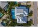 A bird's eye view of a luxury home with a private pool and spa surrounded by tropical landscaping at 227 S Harbor Dr, Holmes Beach, FL 34217