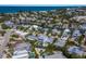Panoramic aerial view of a vibrant coastal community with modern homes, pools, and beach access at 227 S Harbor Dr, Holmes Beach, FL 34217