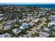 Scenic aerial view of a coastal community featuring modern homes with pools and access to the beach at 227 S Harbor Dr, Holmes Beach, FL 34217