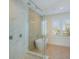 This luxurious bathroom boasts an elegant glass enclosed shower and a freestanding tub at 227 S Harbor Dr, Holmes Beach, FL 34217