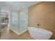 Luxury bathroom featuring a freestanding tub, frameless shower, and spa-like finishes at 227 S Harbor Dr, Holmes Beach, FL 34217