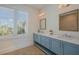 Bright bathroom featuring double vanity, marble countertops, and modern fixtures at 227 S Harbor Dr, Holmes Beach, FL 34217