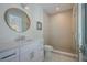 Modern bathroom features a glass-enclosed shower, single vanity, and patterned accent wall at 227 S Harbor Dr, Holmes Beach, FL 34217