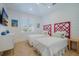 Bright bedroom with stylish red headboards, two twin beds, light walls, and herringbone floors at 227 S Harbor Dr, Holmes Beach, FL 34217