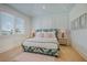 Inviting bedroom boasts a patterned bed frame, stylish decor, and sunlit window with blinds at 227 S Harbor Dr, Holmes Beach, FL 34217