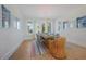 Bright dining room with stylish lighting, seating for eight, and lovely views of the backyard at 227 S Harbor Dr, Holmes Beach, FL 34217