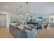 Open concept kitchen with oversized island and seating flows into the living and dining areas at 227 S Harbor Dr, Holmes Beach, FL 34217