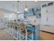 Well-appointed kitchen with a large island, counter seating, and custom cabinetry and lighting at 227 S Harbor Dr, Holmes Beach, FL 34217