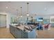 Open kitchen with a large island, pendant lighting, and views of the living and dining areas at 227 S Harbor Dr, Holmes Beach, FL 34217