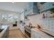 Modern kitchen featuring stainless appliances, quartz counters, stylish accents and ample counter space at 227 S Harbor Dr, Holmes Beach, FL 34217