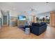 Beautiful living room featuring a large blue couch, coastal decor, and balcony access at 227 S Harbor Dr, Holmes Beach, FL 34217