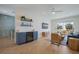 Bright living room features a built-in bar, stylish decor, and sliding doors to a balcony at 227 S Harbor Dr, Holmes Beach, FL 34217