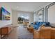 Cozy living room with a stylish blue sofa, decorative molding, and sliding doors to a balcony at 227 S Harbor Dr, Holmes Beach, FL 34217