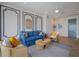 Comfortable living room featuring modern decor, a blue sofa, and a striped area rug at 227 S Harbor Dr, Holmes Beach, FL 34217