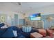Inviting living room featuring comfortable seating, a large TV, and coastal-inspired decor at 227 S Harbor Dr, Holmes Beach, FL 34217
