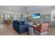Cozy living room with stylish seating, TV, and seamless flow into the adjacent dining area at 227 S Harbor Dr, Holmes Beach, FL 34217