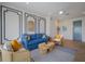 Comfortable living room featuring modern decor, a blue sofa, and a striped area rug at 227 S Harbor Dr, Holmes Beach, FL 34217
